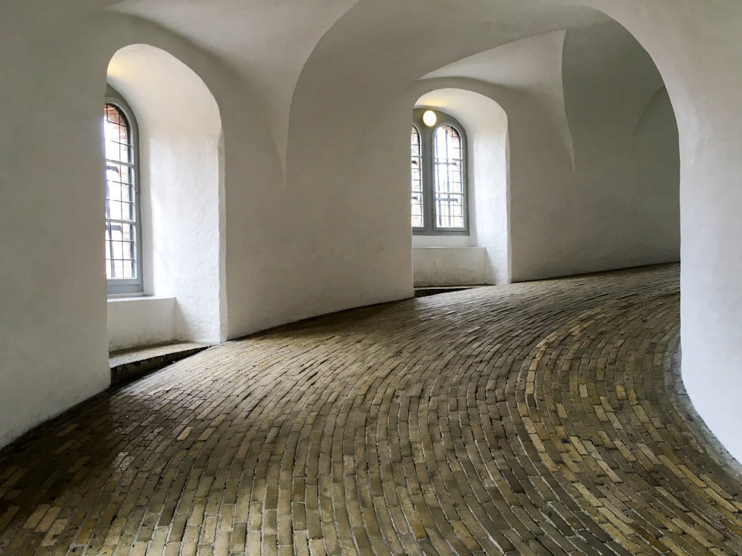 Bright photography studio in Copenhagen with large windows and a wooden floor